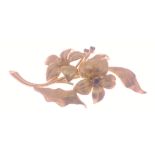 A floral brooch hallmarked 18ct gold set with 3 small blue stones, 6cm long approx, gross weight