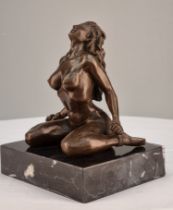 A bronze casting of a Nude with well sculpted detail on solid black marble base