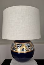 A porcelain blue and cream hand painted lamp with gold embossed detail