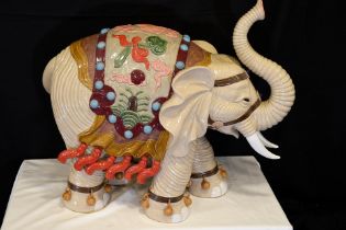 An original Shiwan porcelain elephant which has been hand painted and decorated in fine detail