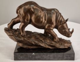 A bronze casting of a Rhino with well sculpted detail on sold marble base