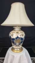 A porcelain blue and cream hand painted lamp with embossed detail