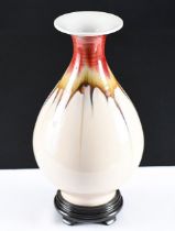 A hand made Chinese porcelain vase with beautiful hand coloured detail using the drip glazing