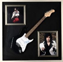 A rare framed guitar which MICK JONES has signed the pick guard and also has signed the words