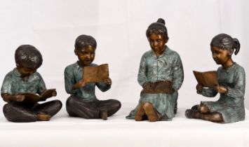 A set of four hand cast bronze figures consisting of 3 children with their teacher