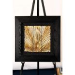 A modern framed art with a gold & silver coloured hand carved wooden panel which has been set into