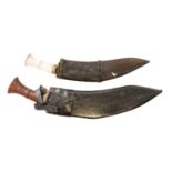 Two Kukri knives and scabbards,