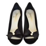A pair of Chanel black satin heels,