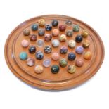 Specimen Stone Marbles on a Solitaire Board