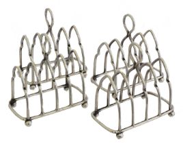 Four silver miniature toast racks,