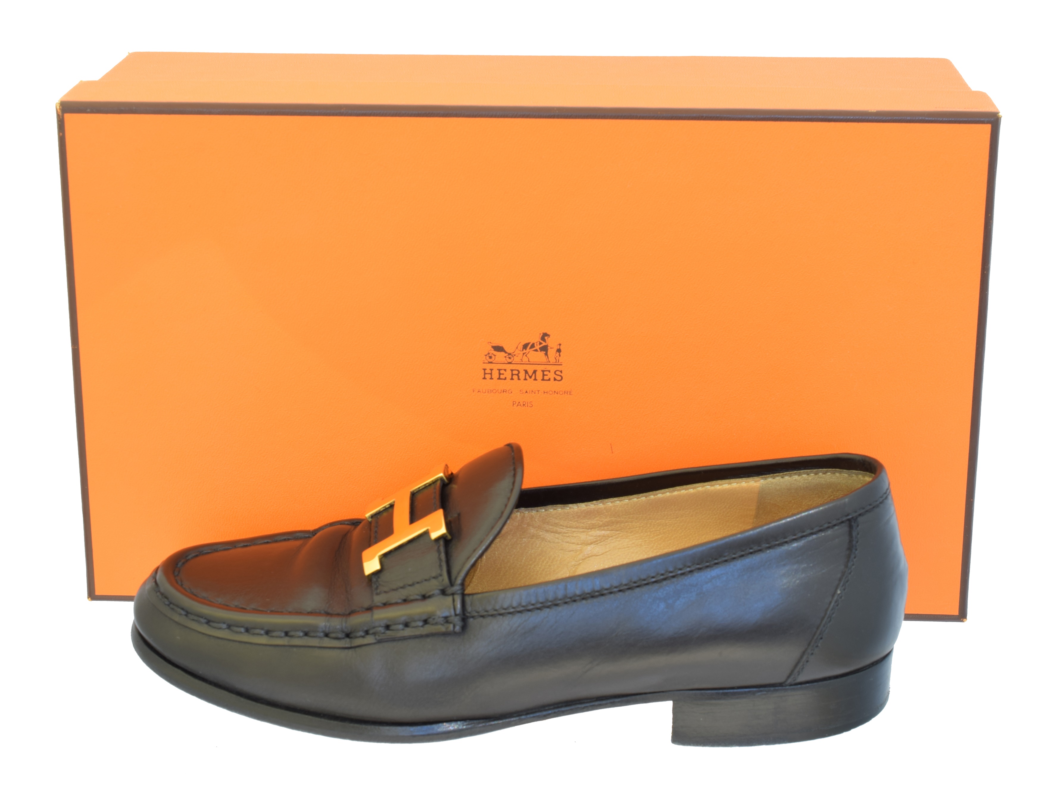 A pair of Hermès black leather loafers,