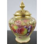 A Royal Worcester covered pot pourri, decorated to the front with fruit to a mossy background by M