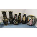 A pair of Carlton Ware vases, decorated with Oriental buildings to a black ground, height 11ins,