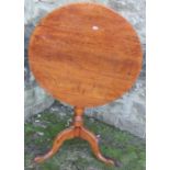 A circular 19th century oak occasional table, raised on a tripod base, dimeter 27ins