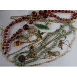A collection of costume jewellery, to include an amber pendant, a green enamel shamrock brooch, a