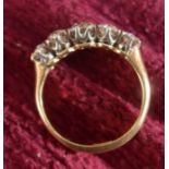 An 18ct gold ring, set with five graduated brilliant cut diamonds, finger size L