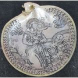 An engraved mother of pearl shell, decorated with a religious scene, diameter 5.5ins