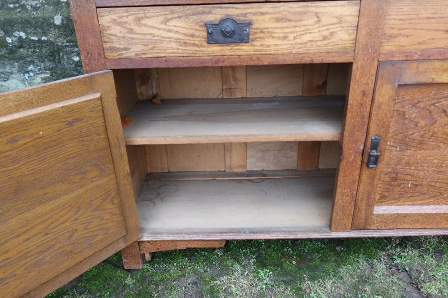 An Arts and Crafts oak sideboard, with graduated shelves, over two drawers, with cupboards below, - Image 4 of 4