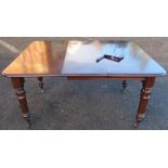 A 19th century mahogany wind out dining table, raised on turned legs, with one leaf, open length