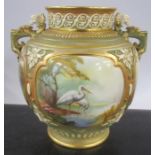 A Royal Worcester quarter lobed vase, decorated with storks wading birds in two panels and landscape