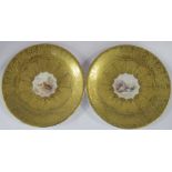 A pair of Royal Worcester dishes, the gilded dishes painted to the centers with partridge and