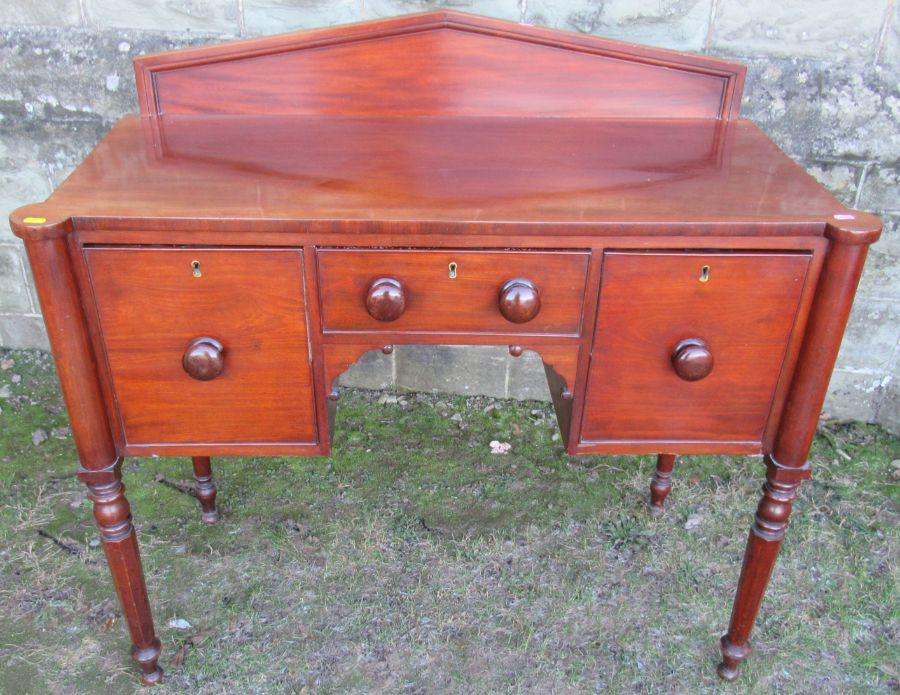 A small 19th century sideboard, fitted with two deep drawers flanking a central drawer, raised on