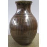 A Peter Arnold Alderney Pottery vase, decorated in black to a brown ground