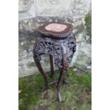 An Eastern hardwood jardiniere stand, with inset marble to quatrefoil top, floral pierced frieze,