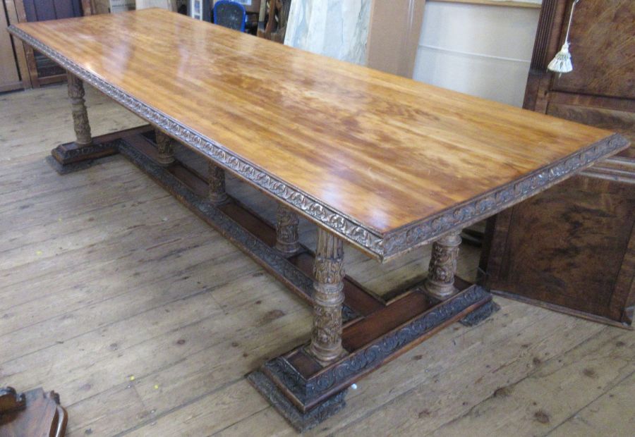 A 19th century Continental refectory dining table, the rectangular top raised on seven legs carved