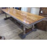 A 19th century Continental refectory dining table, the rectangular top raised on seven legs carved