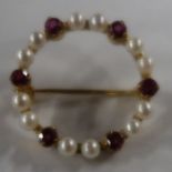 A 9ct gold wreath brooch, set twelve cultured pearls spaced in pairs with six round-cut rubies,