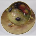 A Royal Worcester miniature cup and saucer, painted with fruit to the inner on a mossy ground, the