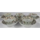 Five 19th century English porcelain tea bowls and saucers, decorated with flowers and swags