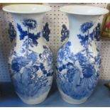 A pair of Oriental baluster vases, decorated to the front in blue and white with birds, having a