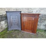 A 19th oak carved corner cupboard, together with another, af