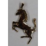 A 9ct yellow gold rearing horse pendant, in the form of the Ferrari badge, London 1979, weight 7g