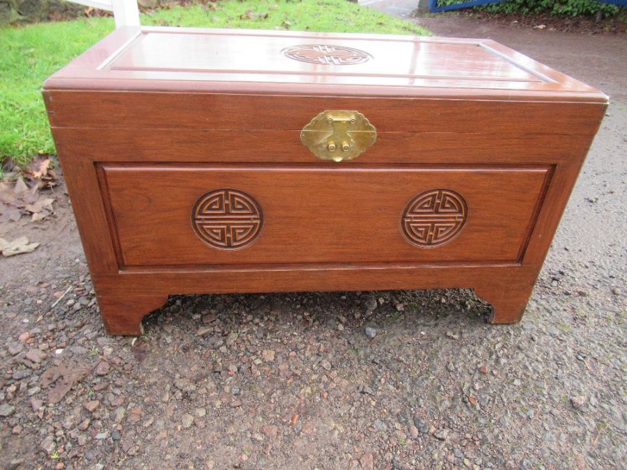 An Oriental chest, carved with good luck sign
