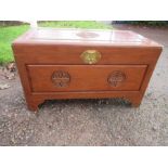 An Oriental chest, carved with good luck sign