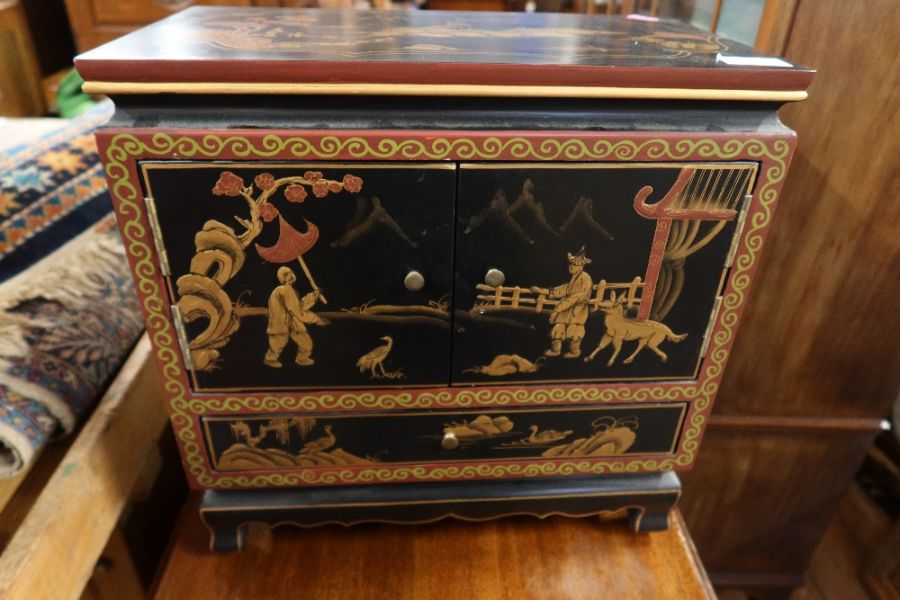 A Japanese lacquer table cabinet, fitted with two doors opening to reveal drawers, with drawer