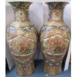 A pair of Japanese vases, decorated with flowers on a blue and crimson ground, height 63cm