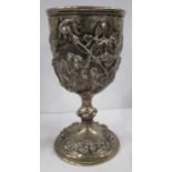 A Victorian silver trophy cup, embossed to the bowl with an Otter Hunt, with knopped stem and the