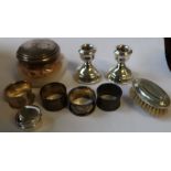 A collection of silver, to include four napkin rings, a pair of dwarf candlesticks, a dressing table