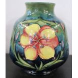 A Moorcroft Pottery vase, decorated in the Flambe Floral Panel pattern, to a greeny blue ground,