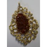 A modernistic design 9ct gold pierced brooch, set with a crystal the center, with pierced textured