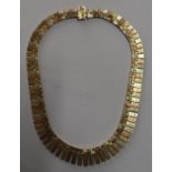 A 9ct gold tri colour block and fringe necklace, with textured finish to the one side, weight 59.5g