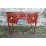 A 19th mahogany sideboard, with lion mask hand handles, raised on tapered legs