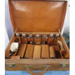 A 19th century gentleman's leather travelling suitcase, fitted with leather holders with eight glass