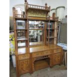 A large Arts and Crafts oak sideboard, with multi mirrored back, ebonised strips, turned columns and