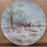 A porcelain plate, decorated with horses and pheasants in a snowy landscape by R Budd, diameter 10.