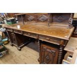 A 19th century oak sideboard, with carved back and two shelves on the barley twist supports, the